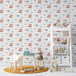 A child's nursery room wall adorned with Cute Cars Wallpaper 07, displaying a variety of colorful cartoon vehicles like buses, cars, and scooters. The fun and vibrant wallpaper creates an engaging backdrop for the room, furnished with a white bookshelf filled with toys and books