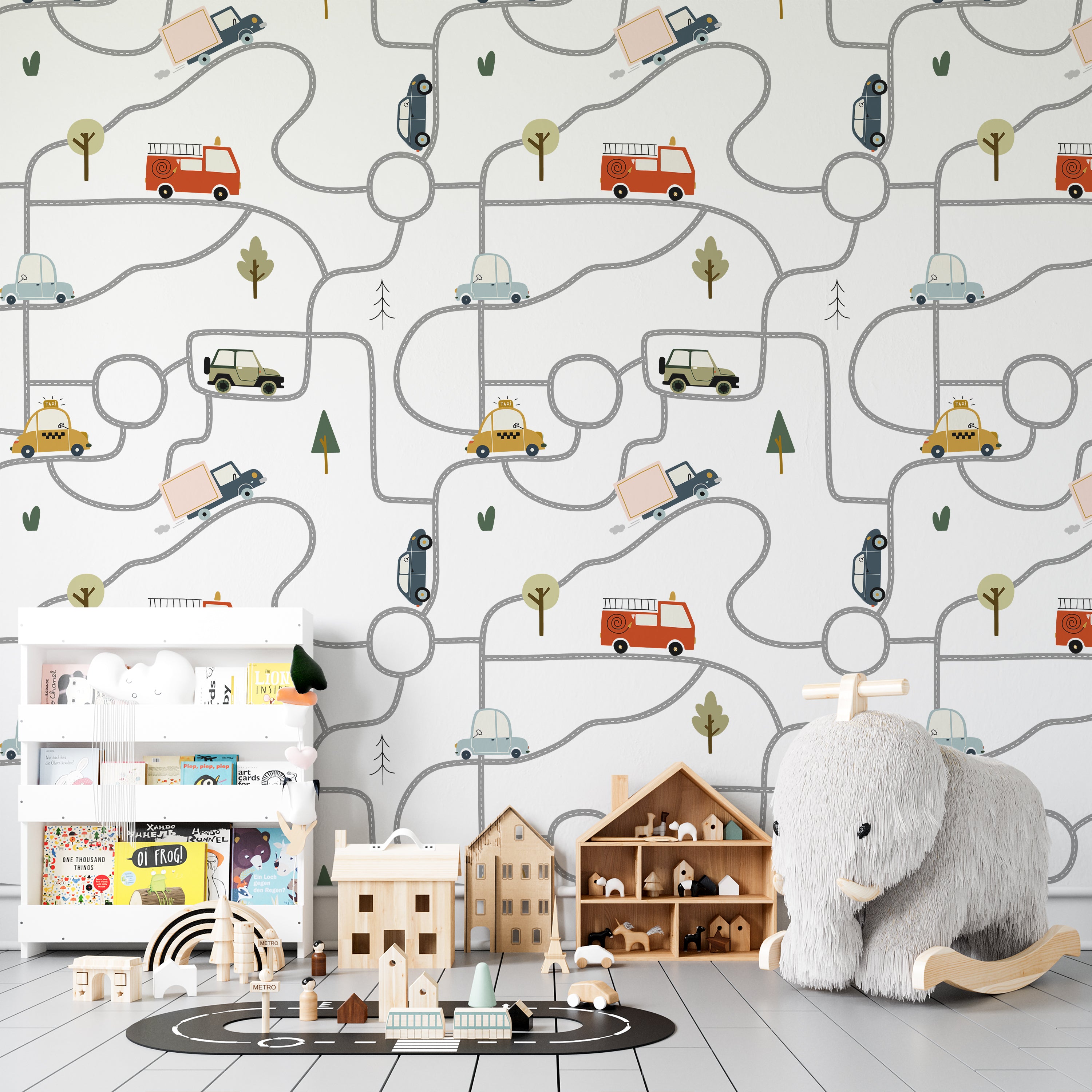 Child's play area with walls adorned by Car and Map Wallpaper, depicting a fun and intricate road map with various vehicles traveling along it. The setting is enhanced with children's toys and wooden furniture, creating an inviting and playful environment for learning and imagination