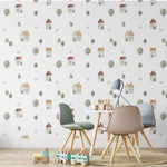 A cozy children's playroom featuring Farm Friend Wallpaper - Happy House, which displays a whimsical pattern of houses with red and yellow roofs, surrounded by green trees and tiny birds, creating a playful and inviting atmosphere.