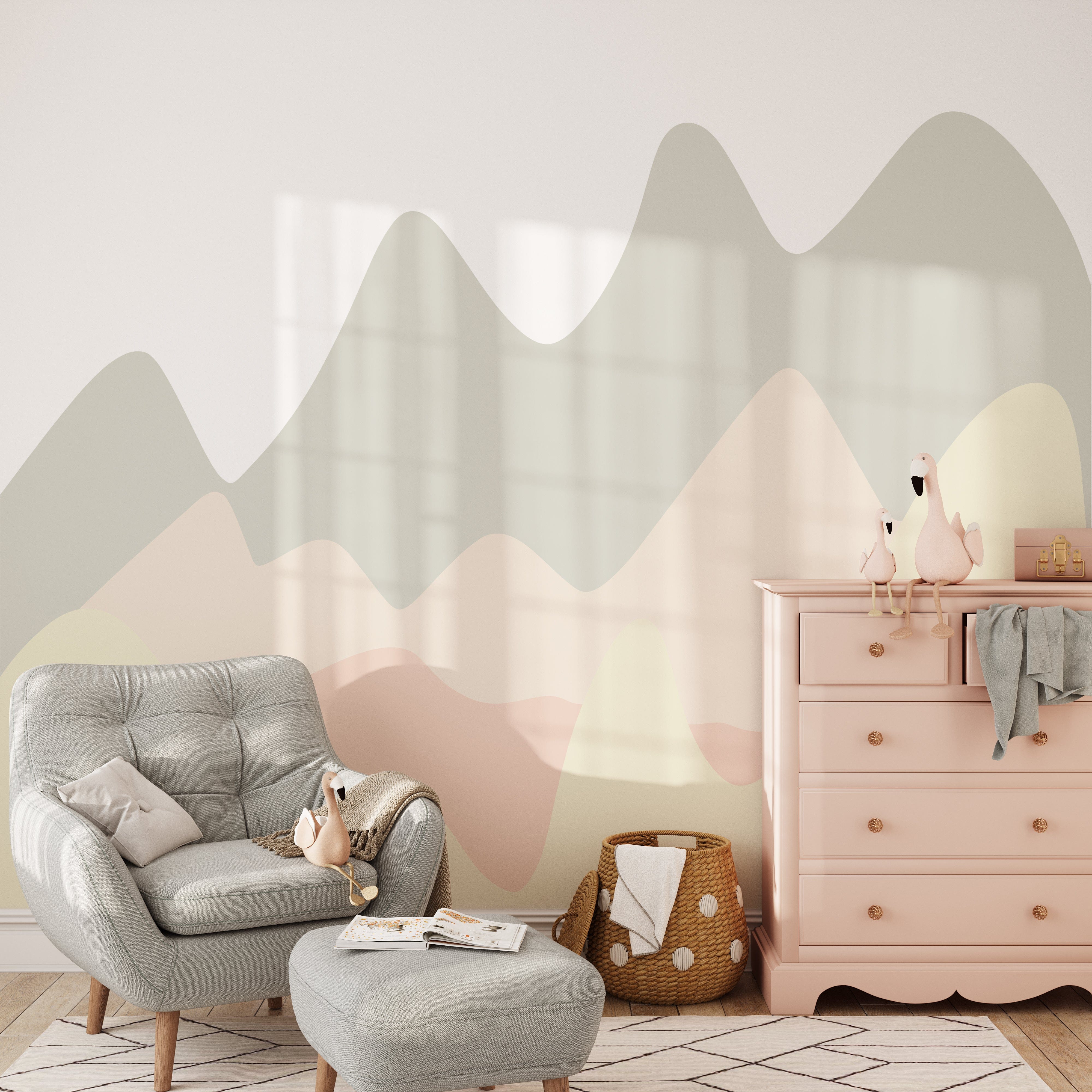 Pastel Hills Mural in a modern nursery setting with a gray armchair, a pink dresser, and decorative plush birds. The mural features wavy pastel hills in calming shades of green, pink, and beige.