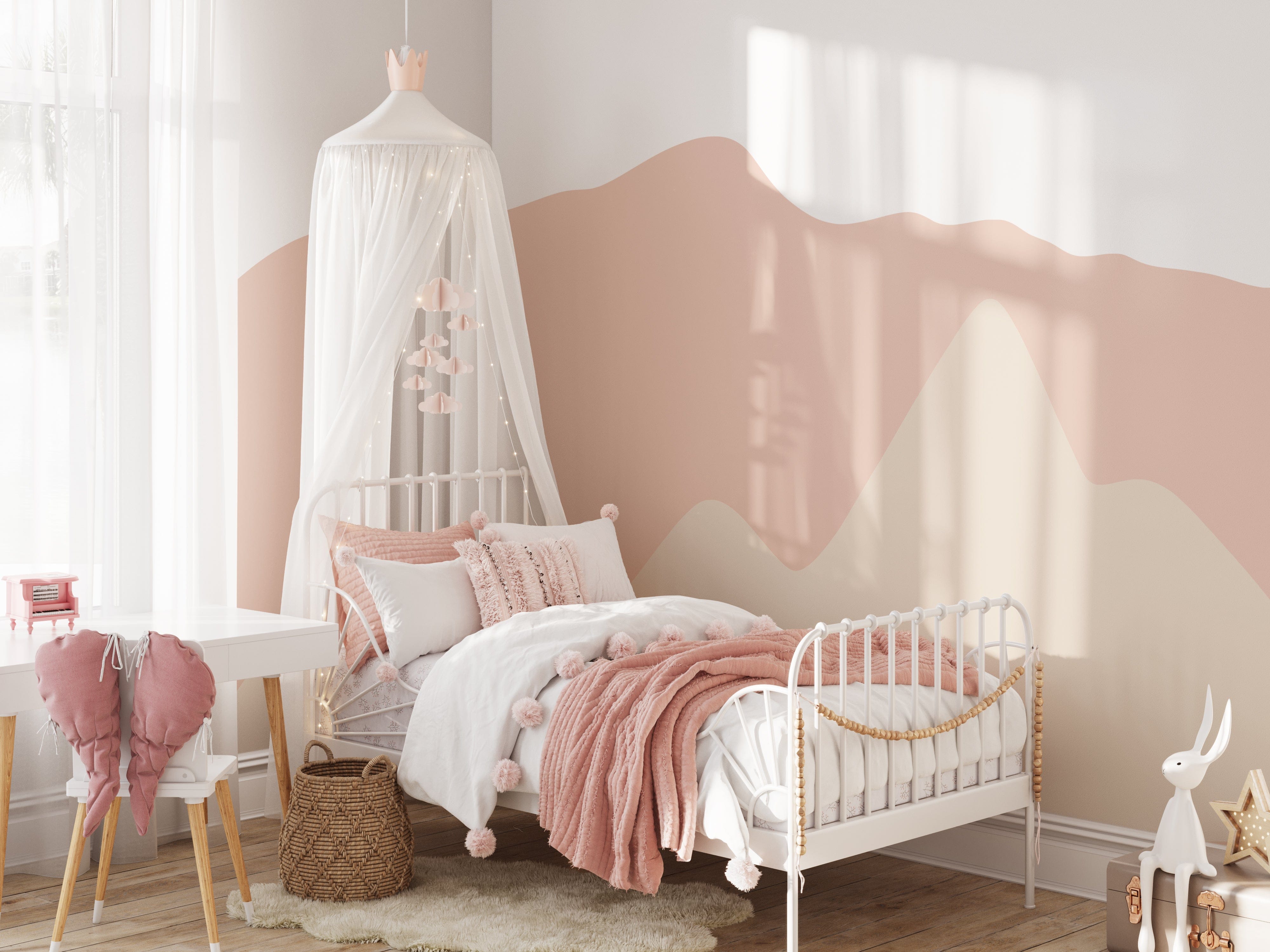 Pretty Hills Mural in a cozy kids' bedroom with a white bed draped with a canopy, pink and white bedding, a wicker basket, and a white desk. The wallpaper showcases soothing wavy pastel hills in shades of pink and beige.