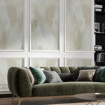 Earthy Aura Paint Texture Mural Wallpaper in a sophisticated living room setting with a dark green sofa, multiple throw pillows, and a minimalist coffee table, emphasizing the elegant and textured wall design