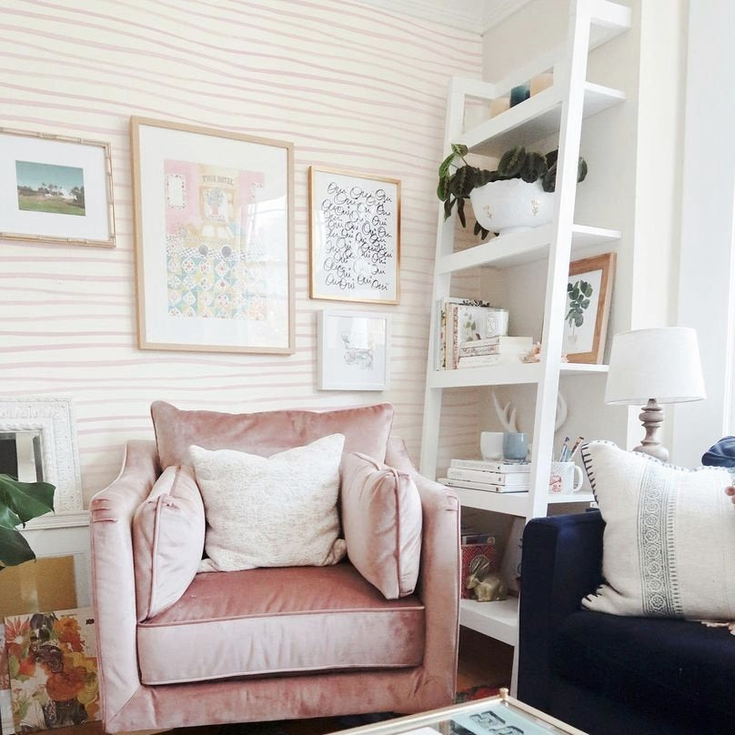 Cozy living room decorated with Minimal Brush Stroke Wallpaper - Blush, featuring soft blush pink brush strokes on a white background, enhancing the space with a minimalist and stylish look.