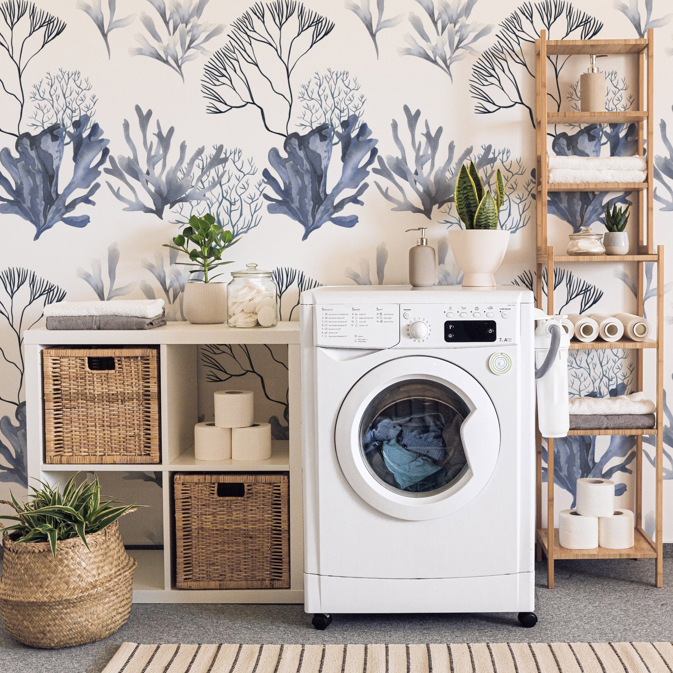 Modern laundry room decorated with ocean coral wallpaper featuring blue and white coral designs