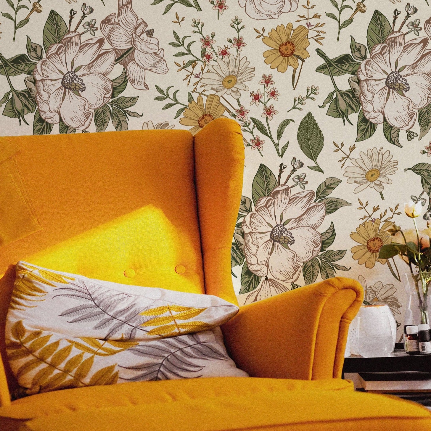 A cozy reading corner featuring a bold yellow armchair against the Floral Wallpaper - Sunny, which complements the chair's vibrant color with its cheerful and sunny botanical pattern, enhancing the warmth and inviting atmosphere of the room.