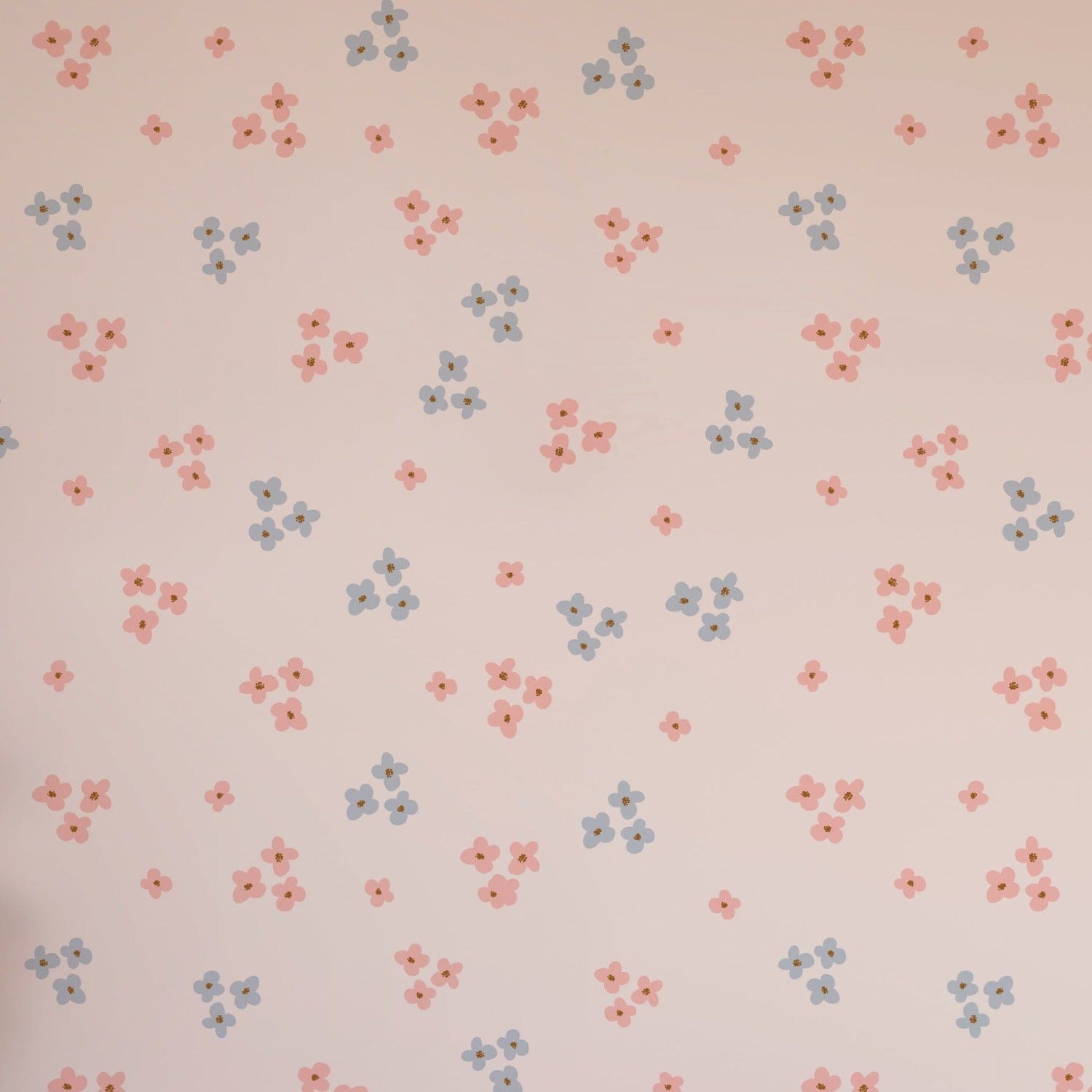 Seamless pattern of small daisies in pink and blue on a light pink background, ideal for gentle and soothing wall decor.