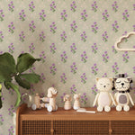 A children’s room corner with the Peaceful Floral Bouquet Wallpaper creating a whimsical and nurturing environment. Wooden toys and child-friendly decor items rest atop a rattan cabinet, harmonizing with the wallpaper's soft floral design.
