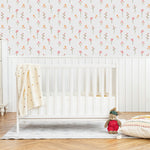 A nursery room adorned with the Gentle Floral Wallpaper, which features an array of small, pastel pink and yellow flowers that bring a serene and cheerful ambiance to the space. The floral theme is perfectly suited for creating a soothing environment for children