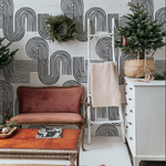 A cozy living space enhanced by the Zen Abstract Wallpaper, which provides a bold yet tranquil background to the vintage furniture and holiday decor, evoking a sense of modern serenity.