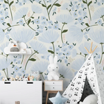 A charming children's play area is brightened by the "Floral Love Wallpaper," which is adorned with delicate blue flowers and soft green foliage on a light background. The space is playfully styled with a child's teepee, a toy chest, and whimsical stuffed animals, enhancing the gentle and joyful atmosphere created by the wallpaper.