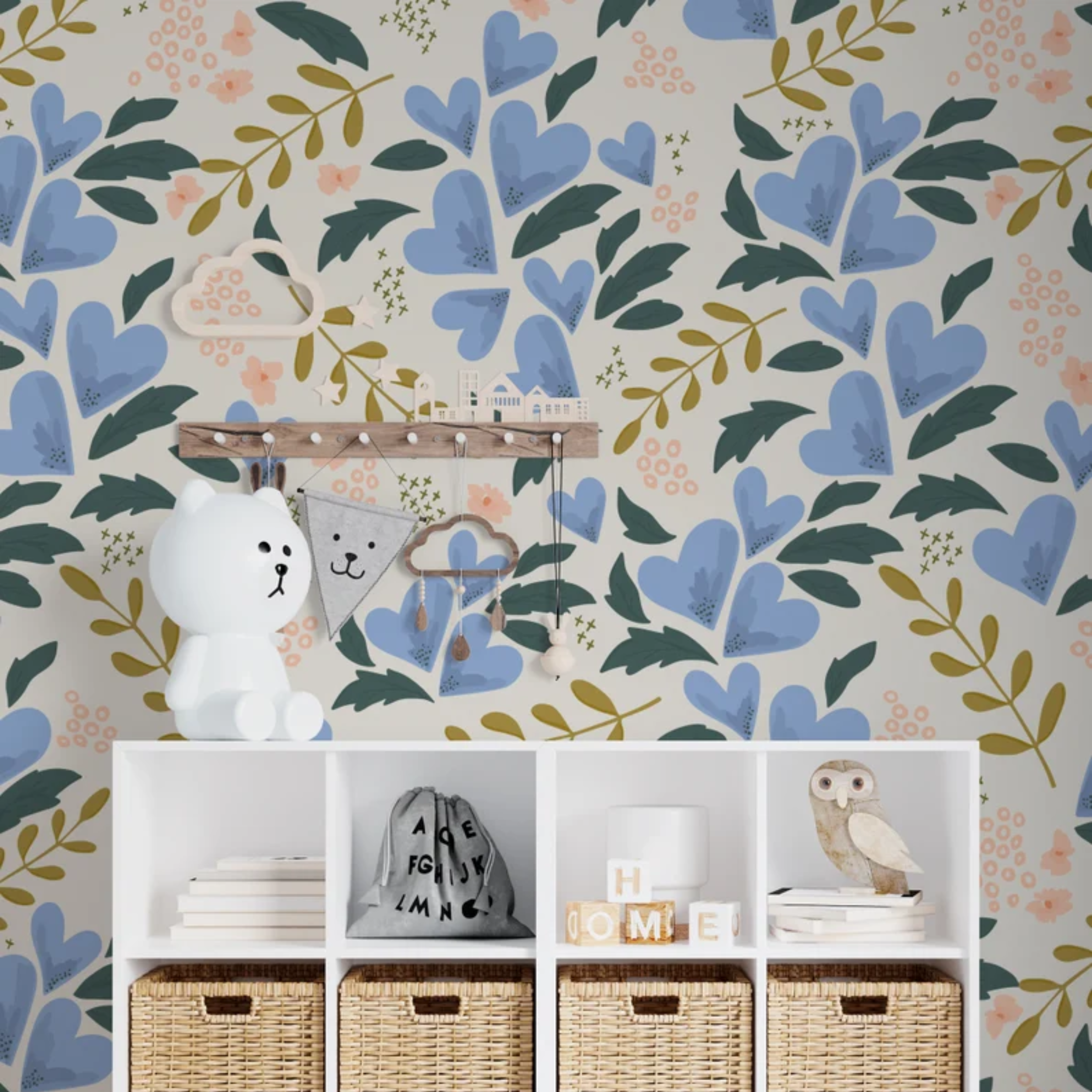 A playful children's room corner enhanced by 'Floral Love Wallpaper II,' which adds a gentle, whimsical touch with its heart-shaped floral patterns and soothing colors, alongside a white shelf with children's toys and decor