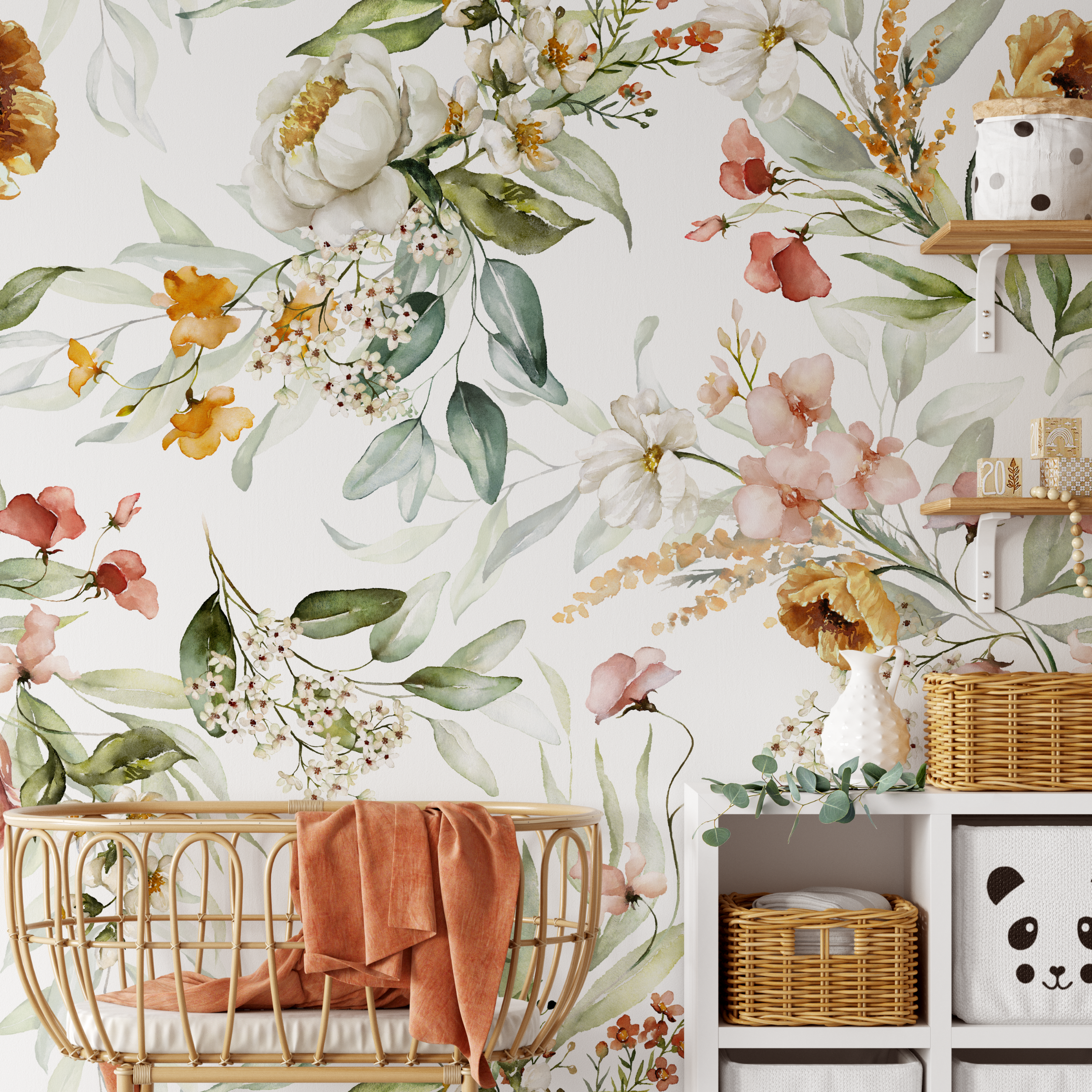 A charming nursery corner with Watercolour Bright Floral Wallpaper adorned with a variety of colorful flowers and leaves. The space includes a wicker bassinet and white shelves, creating a warm and welcoming environment.