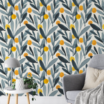 A cozy living space enhanced by the Designer Floral Wallpaper, showcasing its charming pattern of gray foliage and yellow berries, complemented by modern decor and a relaxed seating area