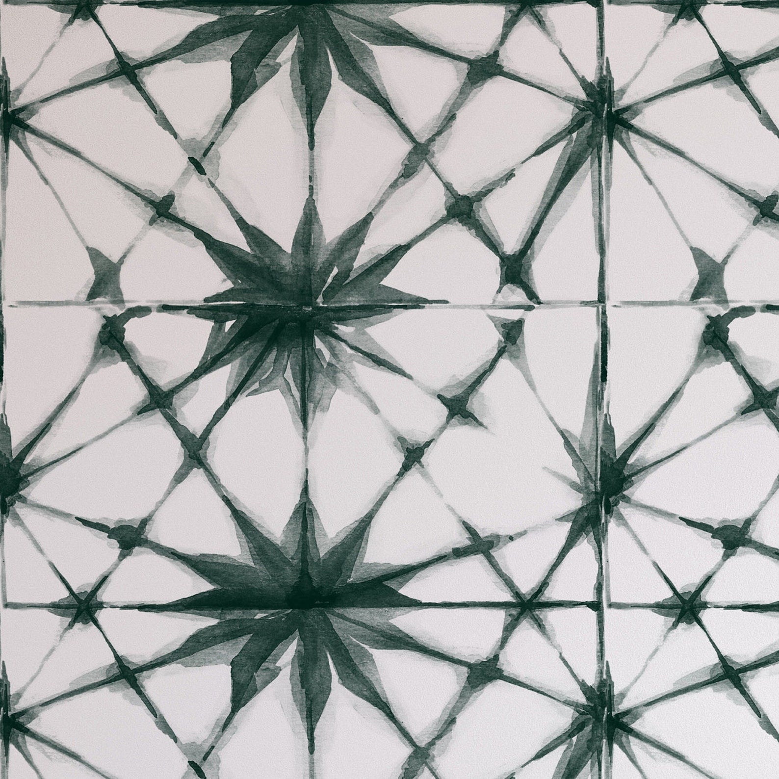 Close-up view of a watercolor wallpaper with a Shibori Star pattern in shades of green, focusing on the geometric star shapes interconnected by thin lines, giving a hand-painted aesthetic.