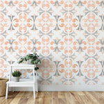 Interior with Moroccan Dream Tile Wallpaper II, showcasing a sophisticated geometric pattern in orange and gray tones. The wallpaper adds a refined decorative element, complemented by a white plant stand and greenery.