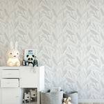 The Nursery Watercolour Floral - Fog wallpaper elegantly enhances a child's room, with its muted gray foliage design that adds a touch of sophistication without overwhelming the space.