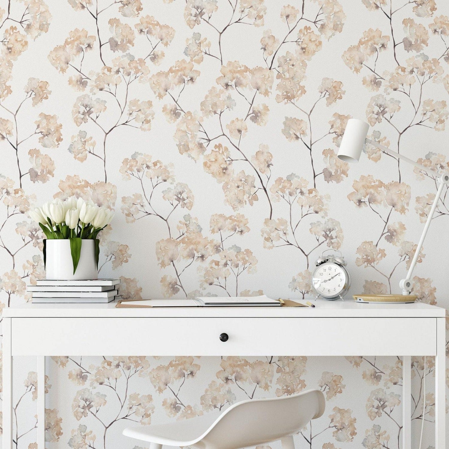 An elegant home office setup featuring 'Pastel and Cream Floral' wallpaper. The design has delicate floral patterns in pastel and cream shades on a light background, adding a soft, romantic touch to the decor. The room includes a sleek white desk, a modern chair, and tasteful desk accessories, enhancing the room's chic, inviting ambiance.