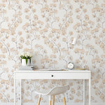 An elegant home office setup featuring 'Pastel and Cream Floral' wallpaper. The design has delicate floral patterns in pastel and cream shades on a light background, adding a soft, romantic touch to the decor. The room includes a sleek white desk, a modern chair, and tasteful desk accessories, enhancing the room's chic, inviting ambiance.