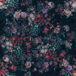 An intricate Dark Luxury Floral Wallpaper - Large adorns a wall with lush, overscaled flowers in deep blues and purples, accented with touches of pink and red, against a dark background, giving a dramatic and opulent touch to the interior space.