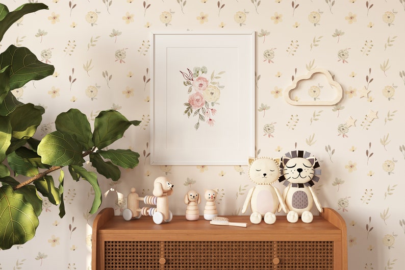 A charming corner of a child's room featuring Sunny Floral Wallpaper with pastel flowers, accessorized with wooden toys and whimsical stuffed animals on a rattan cabinet.