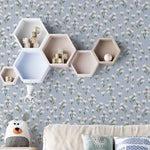 Children's room with Floral Love Wallpaper - Blue, featuring a charming pattern of small white flowers with green stems and yellow centers on a soft blue background, complemented by hexagonal shelves and playful decor.
