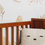 Close-up of Nursery Animal Wallpaper in crib setting with octopus and whale illustrations