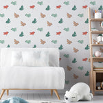 Modern nursery room featuring bird-themed wallpaper in soft green and orange tones with a cozy white sofa.