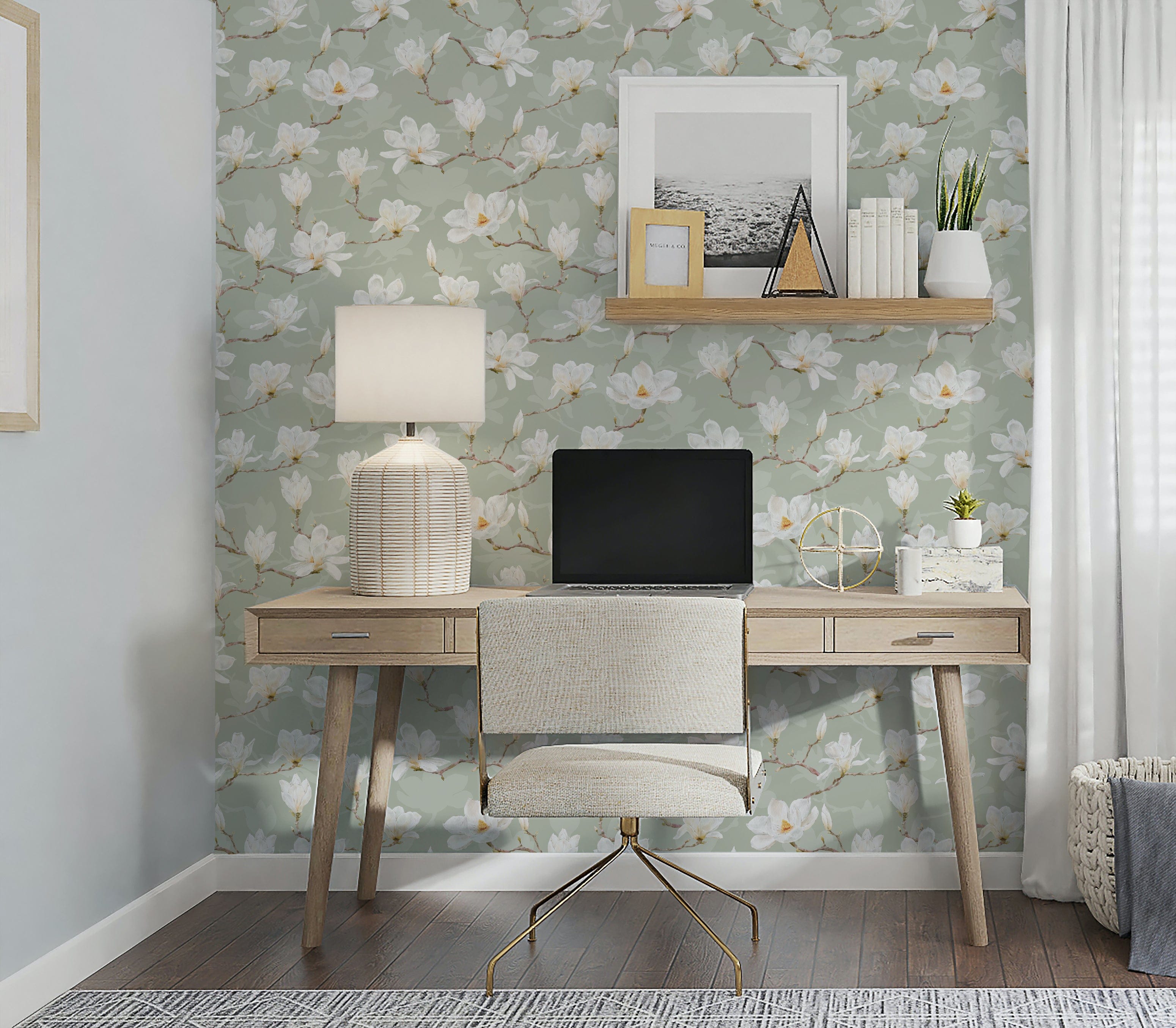 A tastefully decorated home office with the Watercolour Magnolia Wallpaper, showcasing elegant white magnolia blossoms on a pale green background, providing a serene and inspiring environment for work and creativity, accented by natural wood furniture and soft lighting.