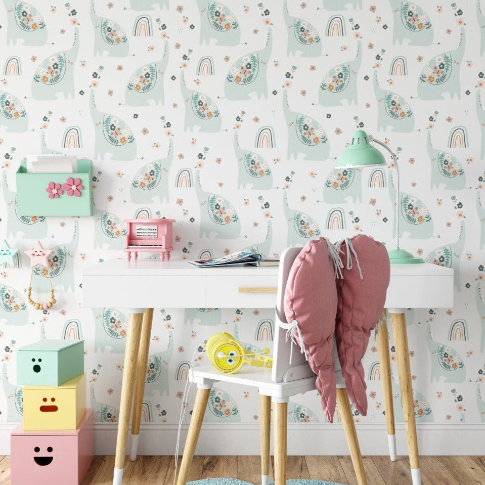 Children's room decorated with Nursery Bloom Wallpaper showing pastel elephants and floral patterns on walls with modern white desk and colorful storage boxes.