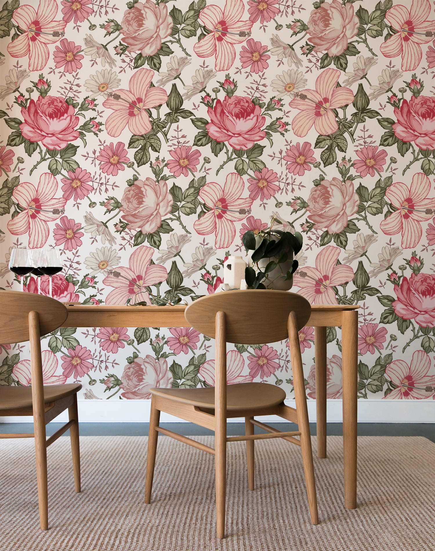 A dining area elegantly enhanced by the Floral Wallpaper - Berry Pink on the wall, which complements the natural wood furniture and the simple decor, including a vase with blooming flowers on the table, creating a warm and inviting space.