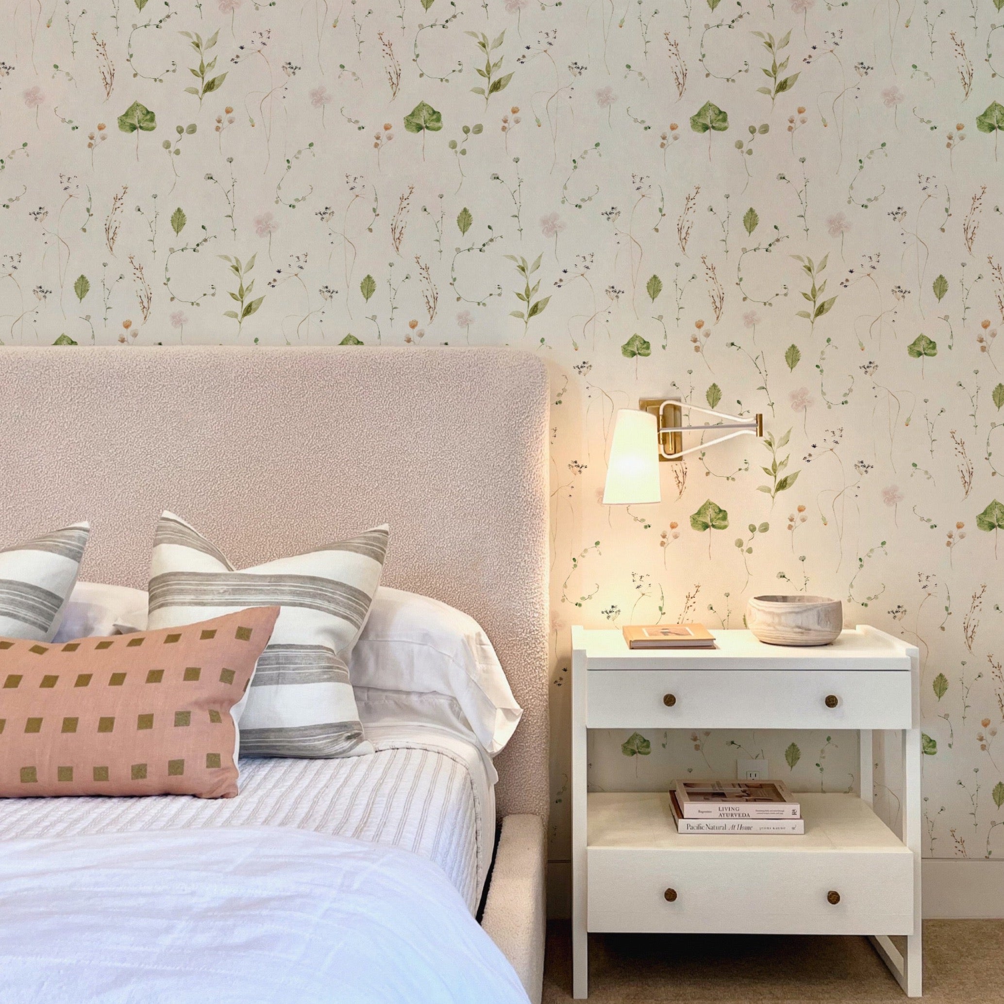 Elegant bedroom decor enhanced by 'Modern Watercolour Floral - Nude Pink' wallpaper, creating a peaceful and serene atmosphere with its subtle floral patterns, complemented by minimalist furniture and soft lighting.