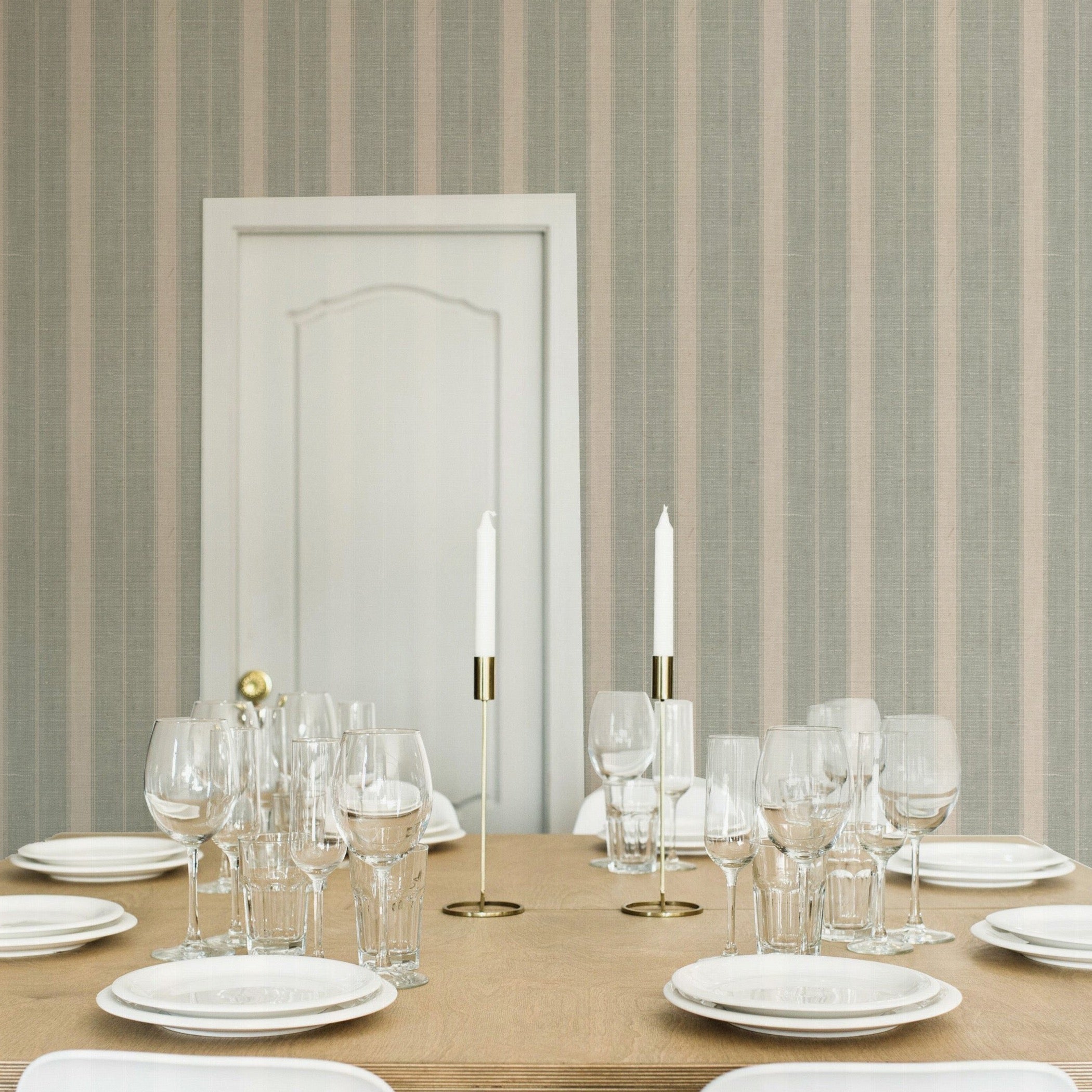 Elegant dining setting with 'Burlap Striped Wallpaper' providing a textured backdrop of vertical stripes, blending seamlessly with a sophisticated table arrangement and white chairs