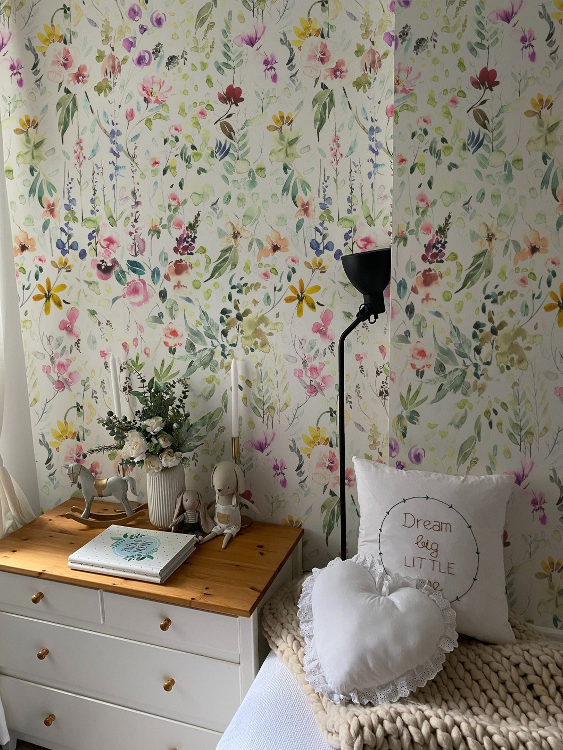 A heartwarming and whimsical children's room adorned with Hera's Floral Wallpaper, where delicate flowers mingle with soft furnishings and playful decor to create an enchanting space for little ones to dream and play.